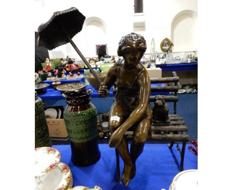 A bronze sculpture of a woman and dog sitting on a bench Condition Report:Available upon request