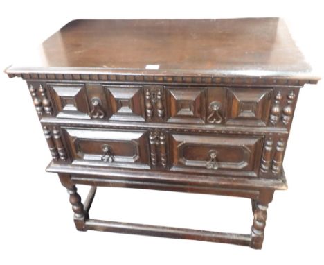 A late 19th century oak Jacobean style buffet chest on base with two long drawers on base with turned supports joined by stre