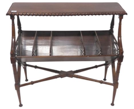 A 20th century mahogany free standing book trough with gadrooned top over five open troughs with pierced dividers on turned f