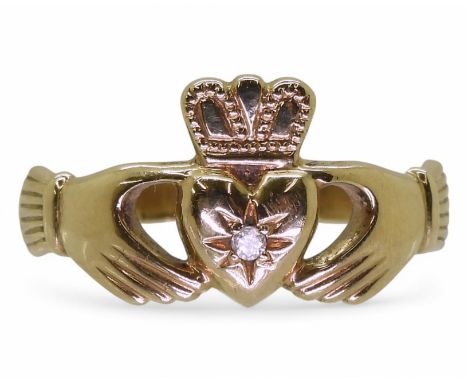 A yellow metal diamond set Claddagh ring, size W, weight 4.7gms Condition Report:Available upon request
