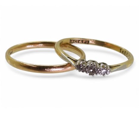 An 18ct and platinum three stone diamond ring, size N1/2, together with a wedding band, size N1/2, weight together 3.3gms Con
