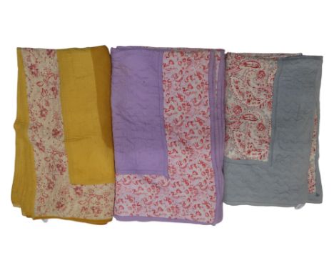 Three 1930s/40s Comfy quilts including pink floral with pale blue surround, 144cm x 170, a pink and lilac example, 172 cm x 2