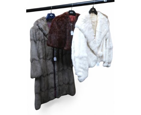 A short white fur jacket, a brown fur shrug and a long grey fur coat, probably chinchilla Condition Report:We would recommend