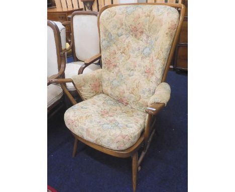 A mid to late 20th century Ercol elm and beech rail back armchair with floral upholstered cushions, 103cm high Condition Repo