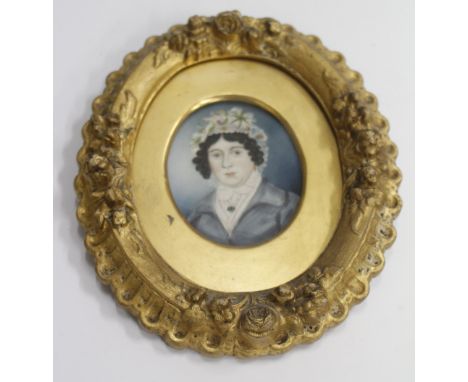 AN ANTIQUE OVAL MINIATURE PORTRAIT of a young girl with a white shawl in a decorative gilt frame 9cm x 7cm 