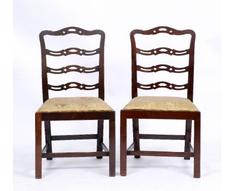 A SET OF SIX CHIPPENDALE STYLE MAHOGANY DINING CHAIRS with wavy ladder backs and drop in seats, c.1880 (some differences), 54