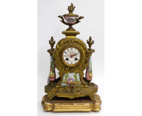 A LATE 19TH CENTURY FRENCH GILT METAL and porcelain mantle clock having an urn finial and Cherub mounts, the porcelain dial w
