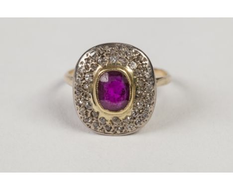 ANTIQUE GOLD COLOURED METAL RING, collet set with a centre rounded oblong ruby and pave surround of numerous tiny diamonds, 2