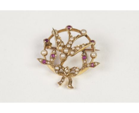 EARLY TWENTIETH CENTURY 15ct GOLD OPENWORK CIRCLET BROOCH, with centre swallow and foliage and ribbon bow to the base, set wi