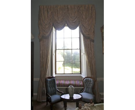A pair of damask silk lined curtains and matching tasselled pelmet. The fabric decorated with a gold and silver floral print,