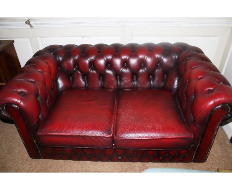 A mid to late 20th century leather button back two seat sang de boeuf Chesterfield sofa