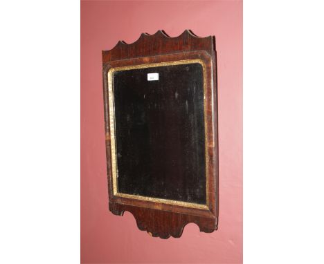 A Georgian wall mirror, 68cm H, 42cm W, with moulded surround and gilt slip