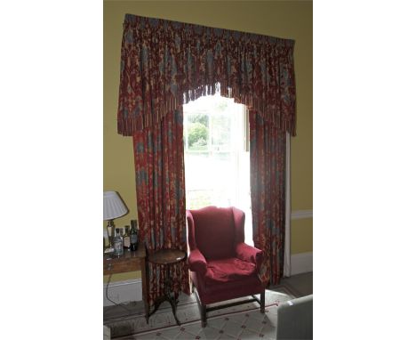 A pair of damask silk lined curtains and matching tasselled pelmet. The fabric decorated with a magenta and gold print, cream