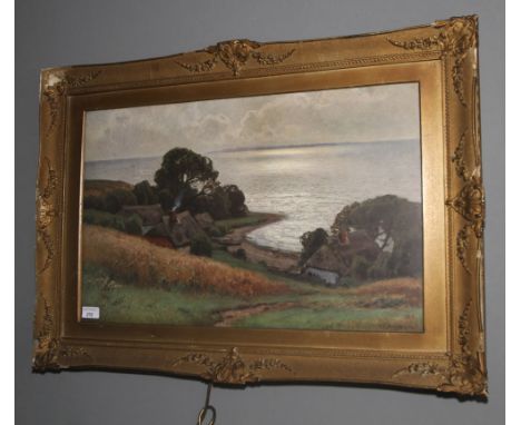 A gilt framed print. 59cm H, 84cm W, of a coastal scene 