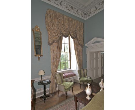 A pair of damask silk lined curtains and matching tasselled pelmet. The fabric decorated with a gold and silver floral print,