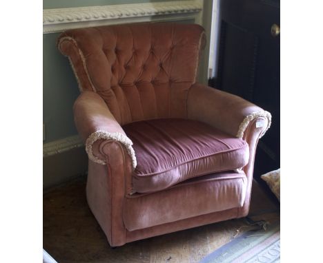 An early/mid-20th century style pink velvet upholstered button back armchair. With castors, 77 cm H x 89 cm W x 70 cm D.
