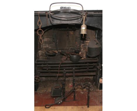 A brass spit jack, various cast iron tools including roasting spits with adjustable height brackets, pot hangers etc  Conditi