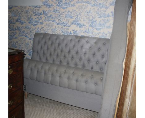 A contemporary button back blue grey upholstered double ended bed