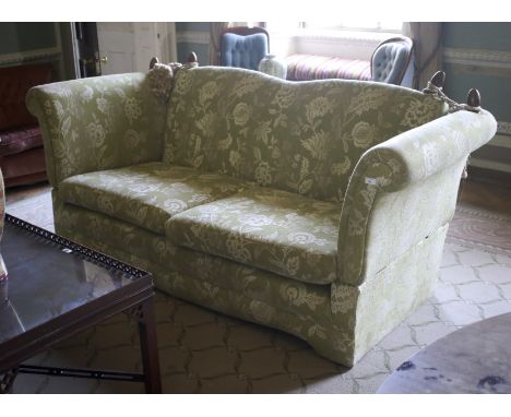 A  contemporary 2 1/2 seat Knole sofa. With full drop sides and twin hump back, with foliate and floral silvered finish on he