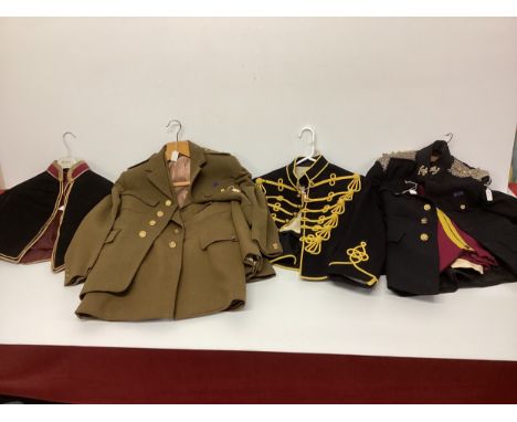 A collection of military uniforms relating to the Royal Hussars to include epaulettes badges etc. 