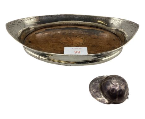 A sterling silver oval coaster or stand with wooden base, Chester 1910. Together with a sterling silver caddy spoon modelled 
