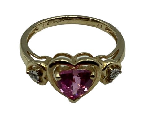 A 10ct gold pink sapphire and diamond ring. Central heart cut sapphire with illusion set single cut diamond accents. Size N. 