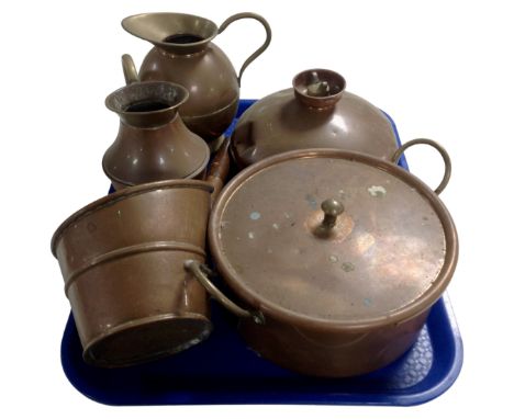 A tray containing antique copper ware including a bed warmer, a lidded pan, ladle and two graduated jugs.