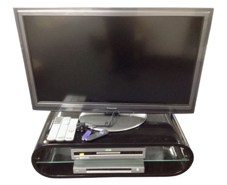 A Panasonic TX-L42 D25 BA LCD TV with Sony DVD player, Sony DVD recorder, on black high gloss stand with remotes and leads 