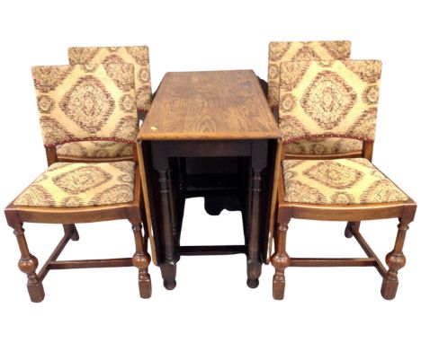 A 20th century oak gateleg table together with a set of four oak dining chairs upholstered in a tapestry fabric.