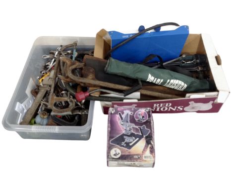 A box and a crate containing assorted hand tools, hand saws, measures, a gas stove, folding stools in carry bags.