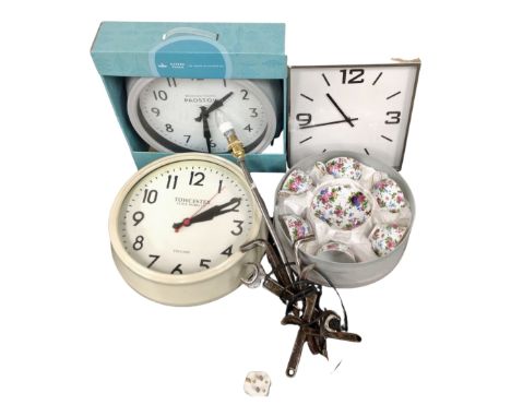 A box containing industrial style table lamp, a boxed tea set, wall clocks.