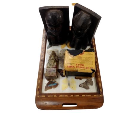 A 20th century tourist butterfly tray together with a pair of carved African bookends, a carved soapstone figure and a Kodak 