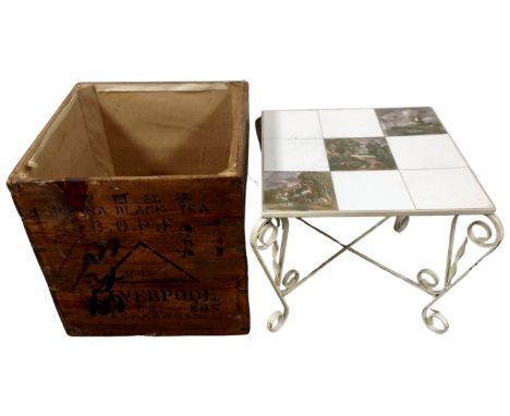 A Chinese pine black tea crate together with a mid-20th century wrought iron tile topped coffee table.