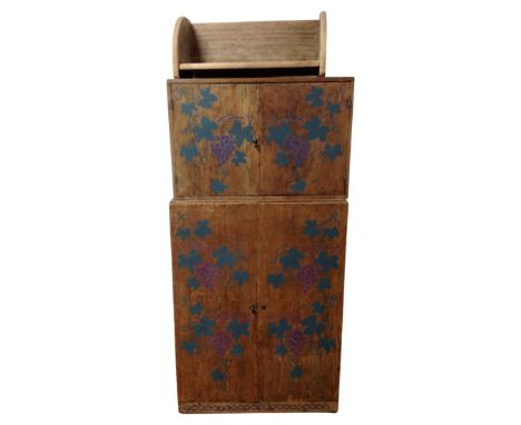 Two pine double door cabinets with hand painted grape leaf decoration, together with a similar book trough.