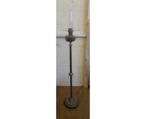 A heavy brass Victorian column oil lamp on tri-pod feet,173 cm tall 