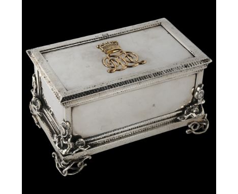 A fine quality Victorian cast-silver and gold desk casket, rectangular form, with hand planished decoration, blossom mounts a