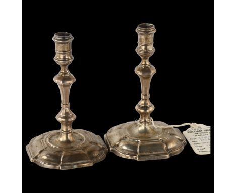 A pair of George II silver taper sticks, with waisted capitals, knopped stems and on moulded shaped square bases, by James Go