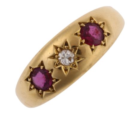 An early 20th century 18ct gold three stone ruby and diamond gypsy ring, set with round-cut ruby and single-cut diamond, hall