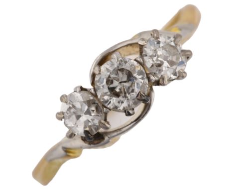 An early 20th century 18ct gold three stone diamond crossover ring, set with old European-cut diamonds, total diamond content