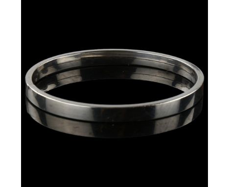 PER E LANGE - a Danish modernist sterling silver torque bangle, band width 6mm, internal circumference 18.5cm, 17.8gNo damage