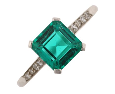 A solitaire emerald ring, set with 1.6ct square emerald step-cut emerald and single-cut diamond shoulders, unmarked white met