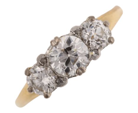 An 18ct gold three stone diamond ring, set with old European and modern round brilliant-cut diamonds with rose-cut diamond ac