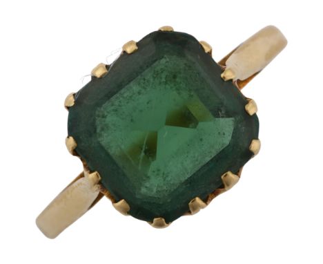 A solitaire green tourmaline dress ring, unmarked gold settings with octagonal step-cut tourmaline, setting height 10.5mm, si