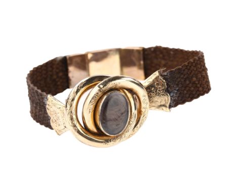A Victorian hairwork mourning bracelet, unmarked gold openwork settings with engraved floral decoration and intricately woven