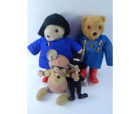 Two Paddington Bear teddy bears, dressed in blue coat and red Wellington boots, and two Mickey Mouse style dolls, (4).