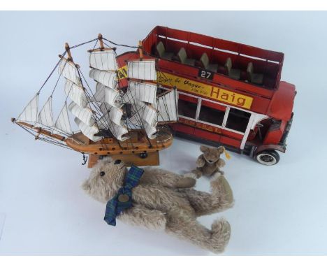 A tinplate scale model of an open topped vintage double decker bus, three masted sailing boat model, Penny Farthing teddy bea