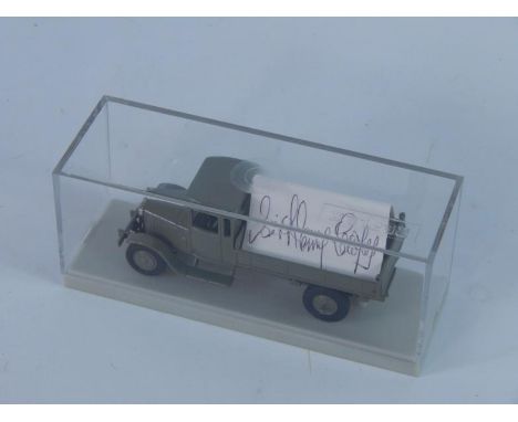A diecast model of a grey vintage truck, boxed, with a card signed by Sir Henry Cooper.
