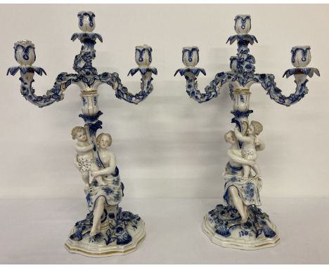 2 antique continental blue and white porcelain 3 arm candelabras. Both with classical female and child figures to base with f