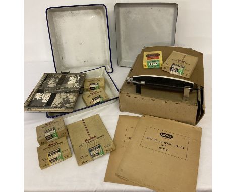 A collection of vintage photographic developing equipment. To include enamel trays, plastic tweezers, a boxed Photax print dr