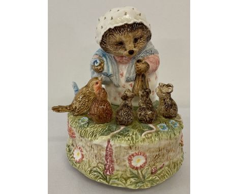 A Border Fine arts ceramic Beatrix potter musical figurine of Mrs Tiggy - Winkle with bird and mice. Plays "In The Garden". S